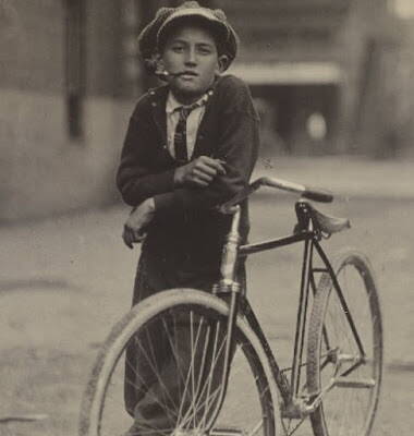 boy smoking leaning on bike ca. 1913.jpg